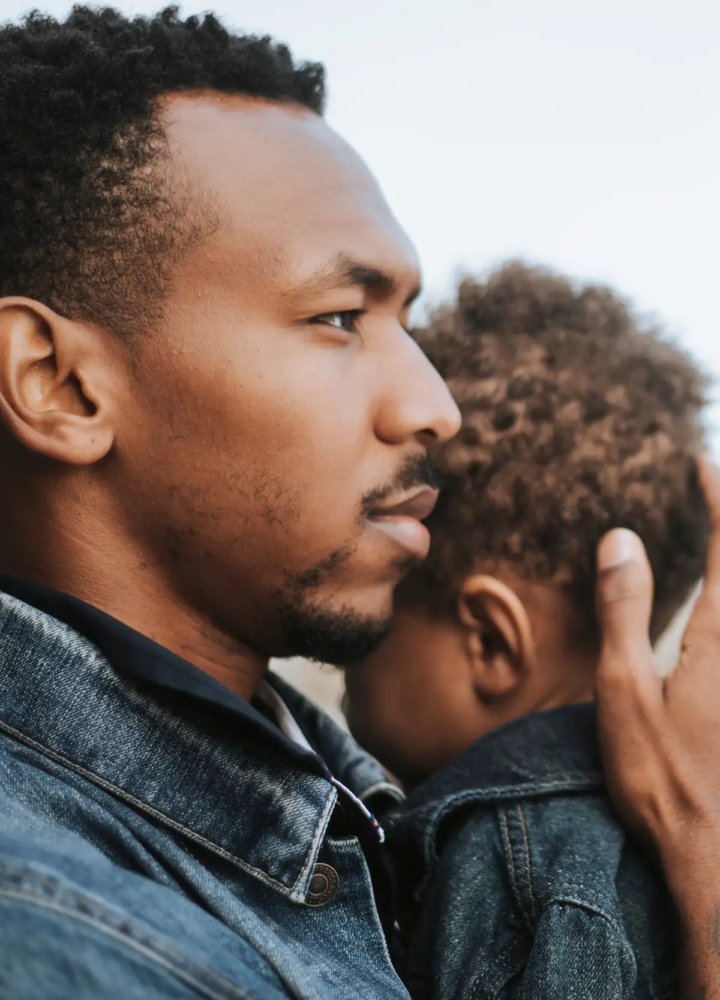 A parent holding a young child